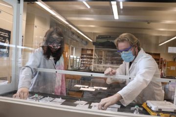 Two students test detergent in lab