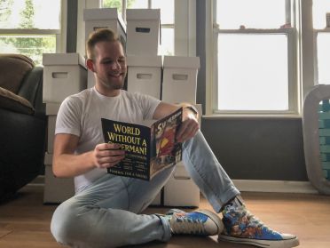 Student Evan Davis reading a Superman comic book