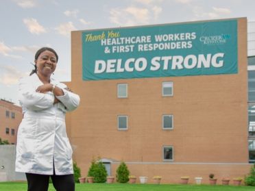 Monjama Korngor poses outside of the Chester-Crozer Medical Center building where she works.