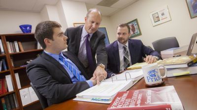 Two accounting major students invest their time at an alumni accounting firm. This real-world experience prepares them with the best tools as they earn their accounting bachelor's degree.