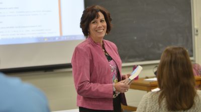 Organizational Development & Leadership Professor Holding Book