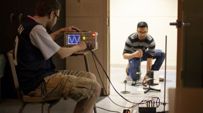 Students with physics equipment