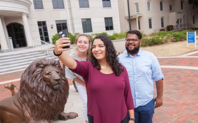 Student Selfie at Pride Statue