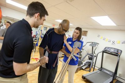 PT students helping patient walk