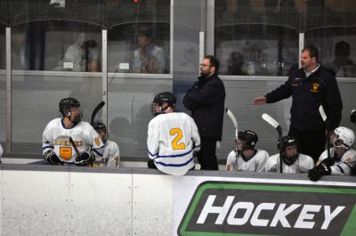 Ice hockey team on the bench with coaches