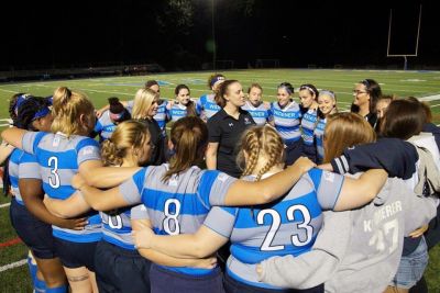 Women's rugby team in a huddle
