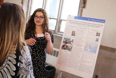 Student presenting at the High-Impact Practices Fair