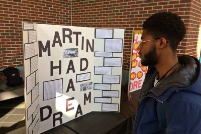 Student looks at MLK Day poster