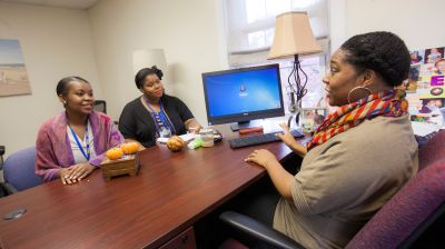 msw degree students sitting at desk in office discussing master of social work program and progress toward their social work masters