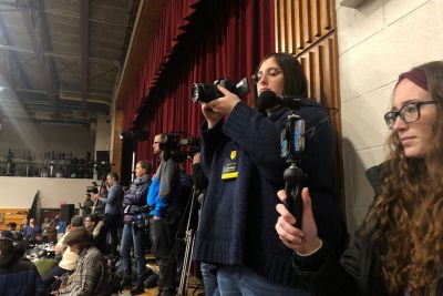 Students film at a political rally for the New Hampshire Primary