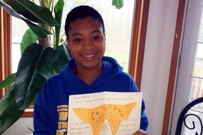 Student holding a card of encouragement for hospice workers and patients