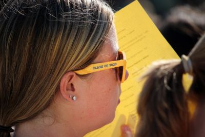 Student wearing yellow sunglasses that say 'class of 2020' on the side