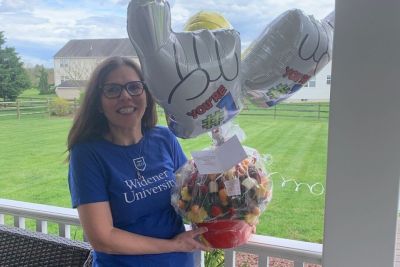 Professor Catherine Safran holds a gift basket