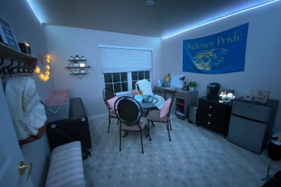 Room with table and chairs and Widener Pride flag on the wall