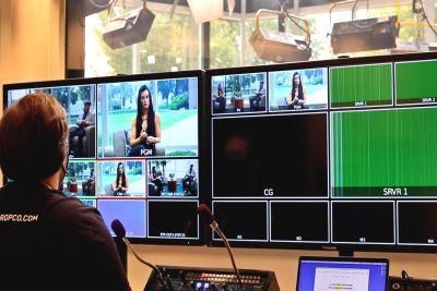 Person working in the TV studio, watching several monitors