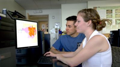 two students working on computer using heat mapping software