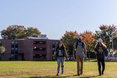 Masked students walking on Memorial Field