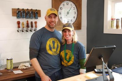 Volunteer Brewing Co. owners at the brewery, wearing brewery T-shirts and hats