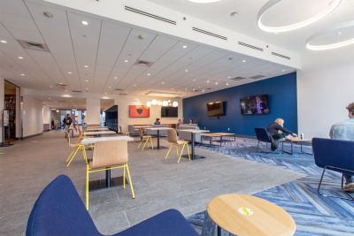 Renovated University Center with tables and TV screens on the wall