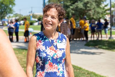 President Julie Wollman greets students and families at move-in day