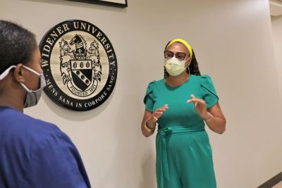 School of Nursing professor engages with Widener University nursing student.