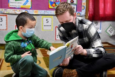 A male graduate student works with a young child at Widener's Child Development Center.