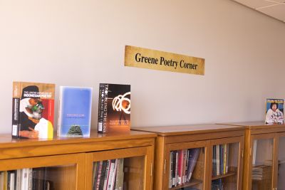 Greene Room signage above a fully stocked bookcase.