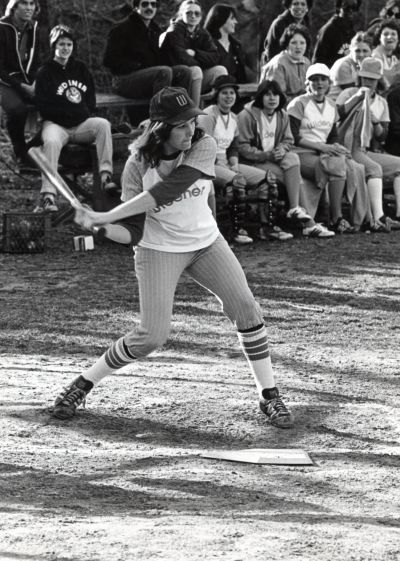Black and white image of a Widener softball player swinging the bat