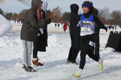 Gabby Nye runs during the NCAA cross country championship in the snow in Michigan.