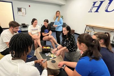 Student athletes playing a game in the HUB space