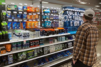 Student looking at aisle of shaving products