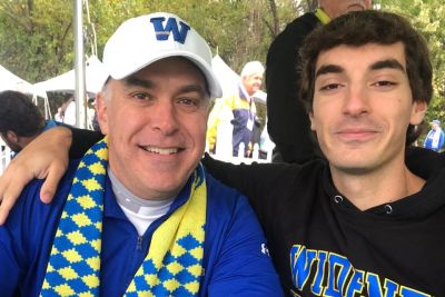 Richard Massi '97 and his son Kane Massi pose for a photo at the 2023 Homecoming celebration.