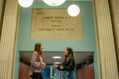 Students Emma Lavin and Saleeth Ulloa Lasso talking in hallway of Kapelski Learning Center