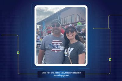 Two people pose smiling for the camera wearing Phillies shirts. The photo is on a blue background with yellow details.