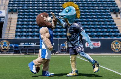 Chester and Phang mascots high-fiving on the field at the Philadelphia Union