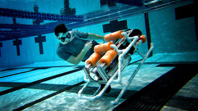 Widener University student with robosubmarine in pool
