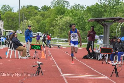 Matayo McGraw, wearing a Widener track shirt, runs on a track as he prepares to jump