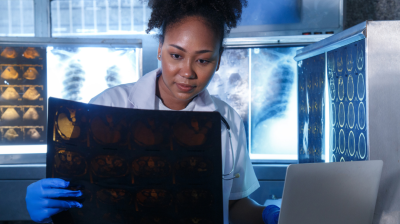 An X-ray tech examines images of the brain.