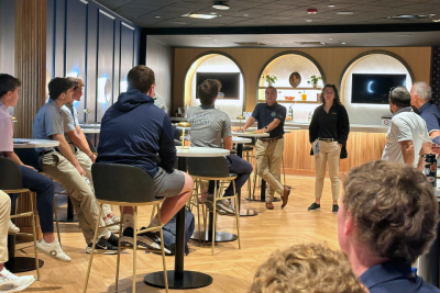 Faculty speak to students in a high-end hospitality setting at Subaru Park