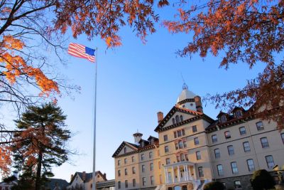 American flag flies out of Old Main.
