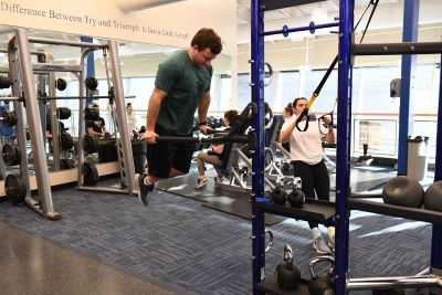 Two students working out on equipment at Pride Recreation Center
