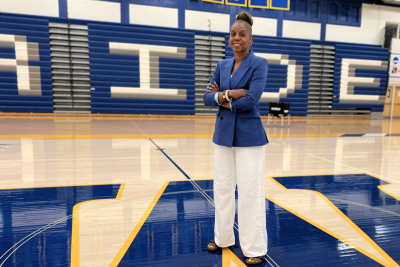 Athletics Executive Director Crystal Gibson stands center court in the gym