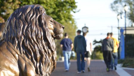 Students Walking Behind the Pride