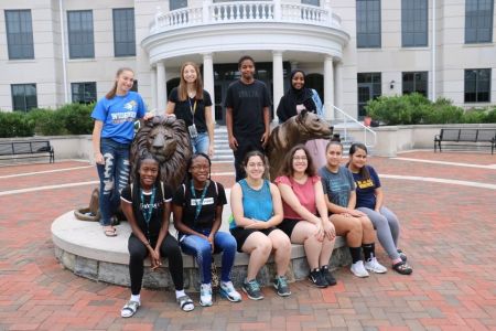 Widener twins in front of Pride statue