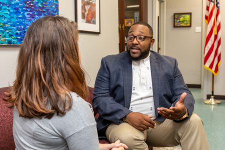 Master of Public Administration student Malcolm Yates speaking with an individual