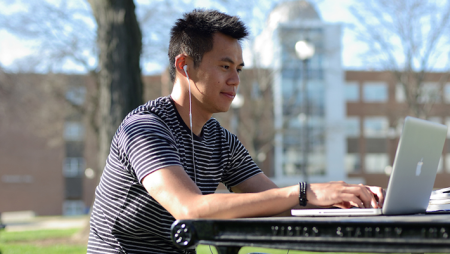 Student on laptop on Widener campus