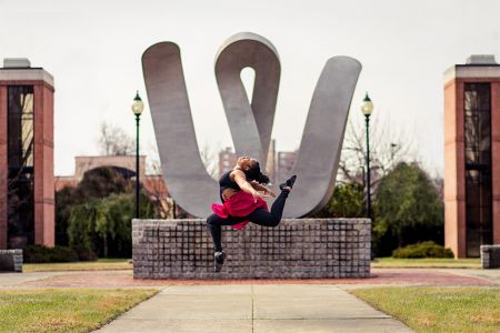 Dancer at the W statue 960x640 Dance student in a mid-air jump in front of the 'W' statue