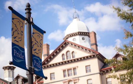 Widener Pride Flag infront of Old Main building