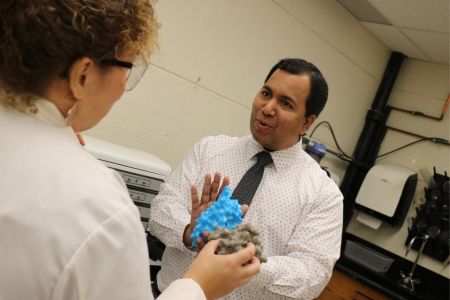 Professor Sachin Patil working with students in the NanoBio Lab.