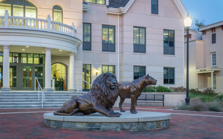 Widener's Pride statues, outside Founders Hall, the nursing building, at dusk